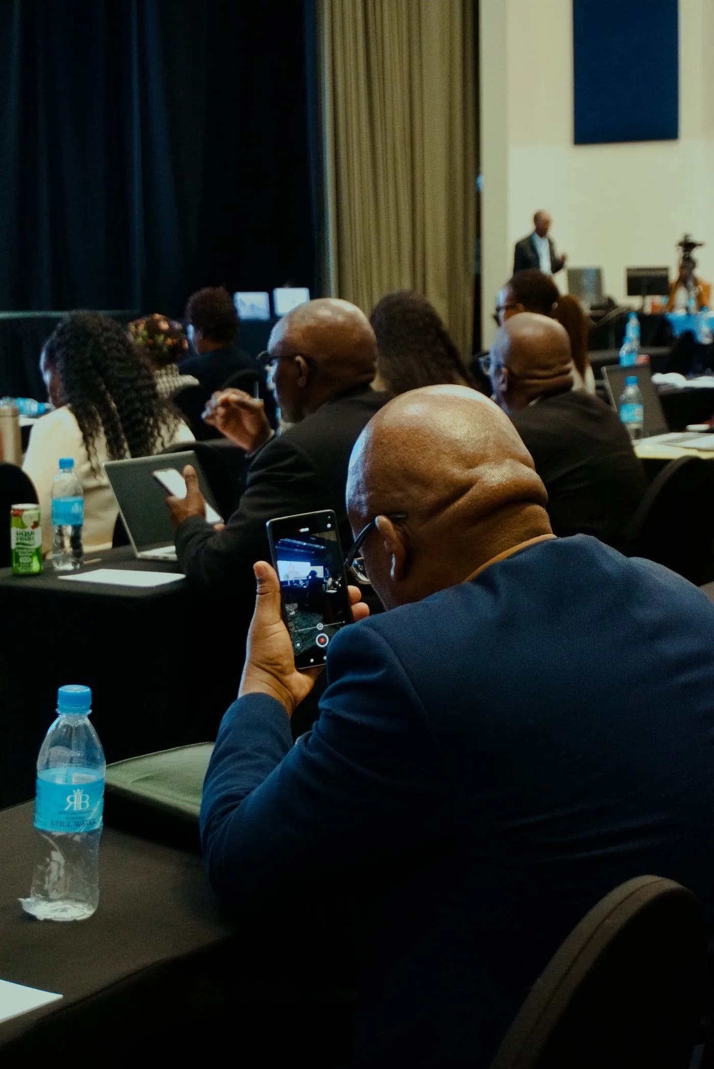 Illustrative photograph of delegates listening at a conference